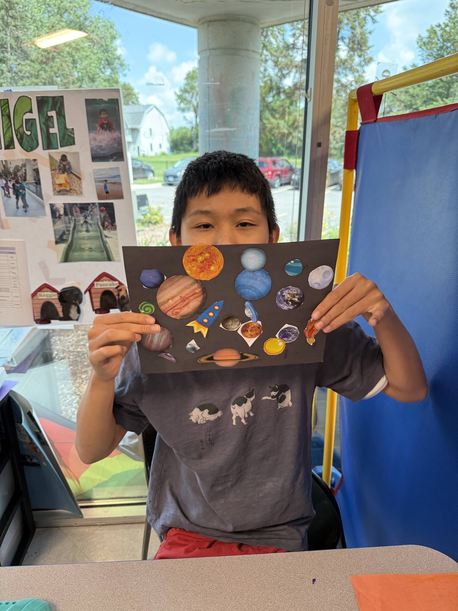 Student proudly holding an art project