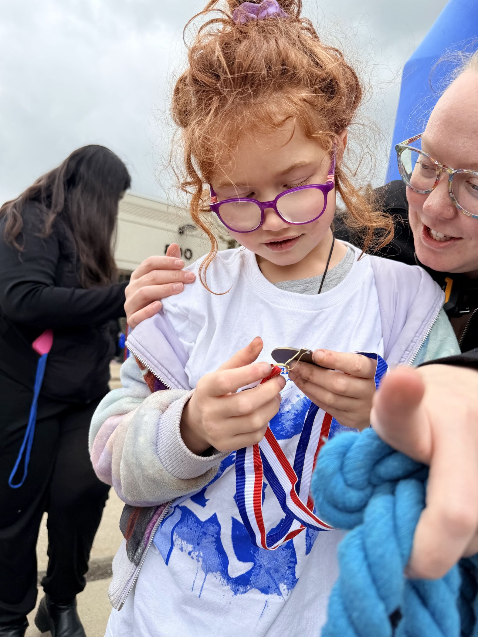 Student receiving a medal at the Fun Run