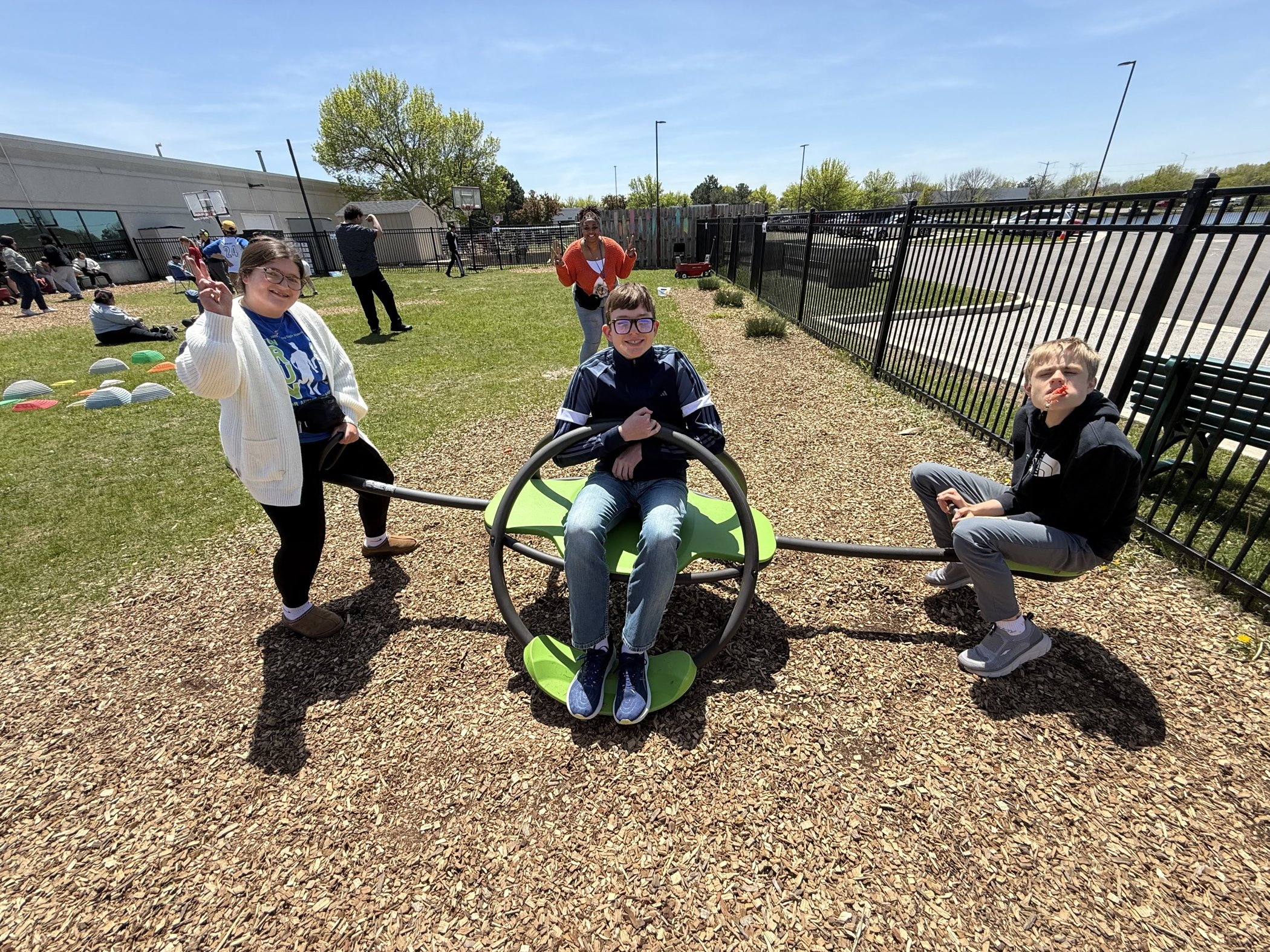Students on a single spinner on a woodchip lot